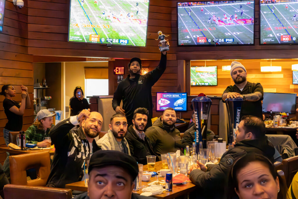 Bobby V’s Stamford main bar with the two story media wall and 80 foot onyx bar